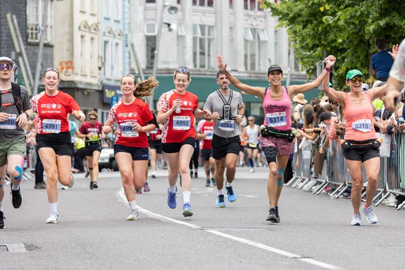 Marathon runners celebrate closing in on finishing line