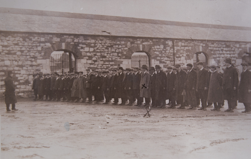 1955.14.7D-D7.3-Postcard-Irish-Volunteers-Drilling-in-Cornmarket-Yard-Terence-MacSwiney-150-x-75