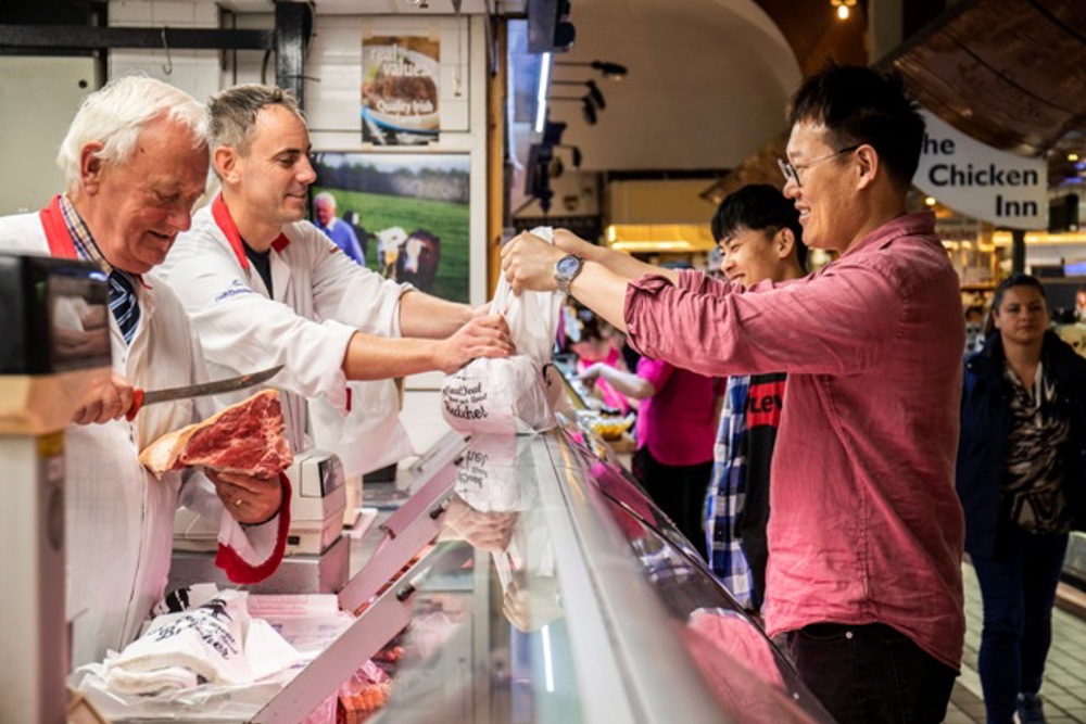 Employee handing purchase to customer