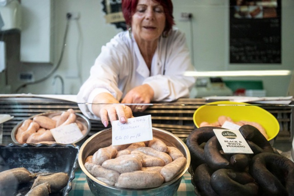 Staff labelling chicken display